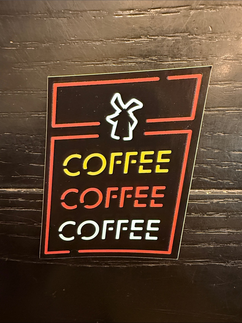 Dutch Bros Neon-Style Coffee Sticker — Black with Yellow, Red, White Accents